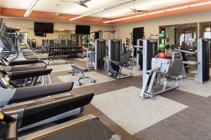 Francis Property Management A gym room equipped with tread machines and televisions, available for residents of Apartments For Rent managed by Francis Property Management.