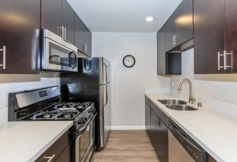 an-inviting-kitchen-featuring-stainless-steel-appliances-and-elegant-wood-cabinets-can-be-found-in-these-apartments-for-rent-hollywood-ca